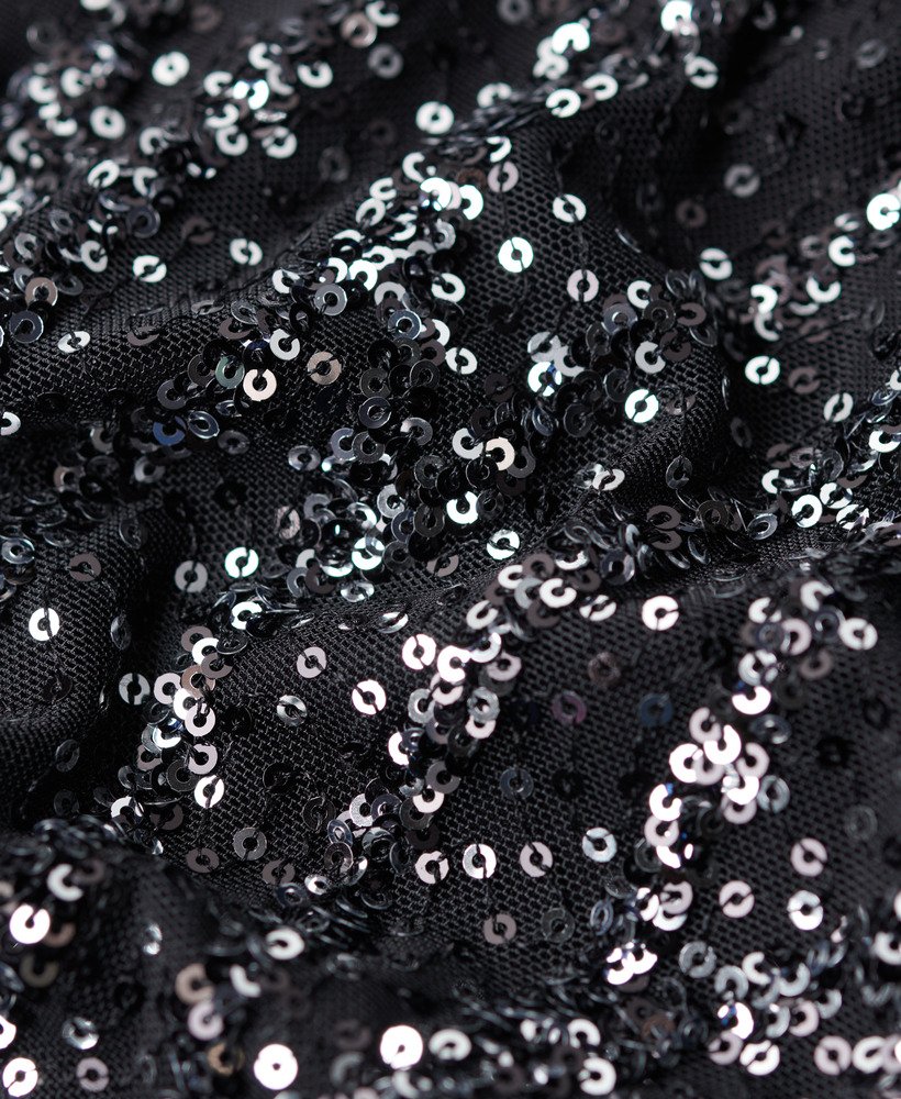 top cropped de manga comprida com lantejoulas pretas.
