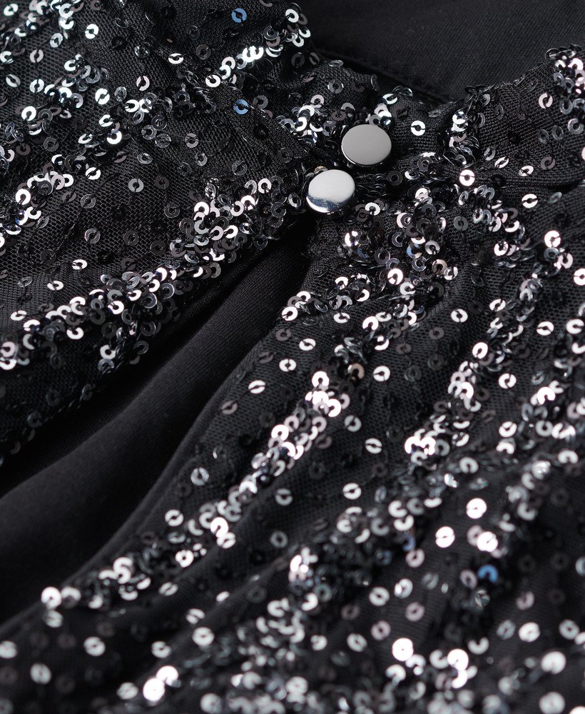 top cropped de manga comprida com lantejoulas pretas.