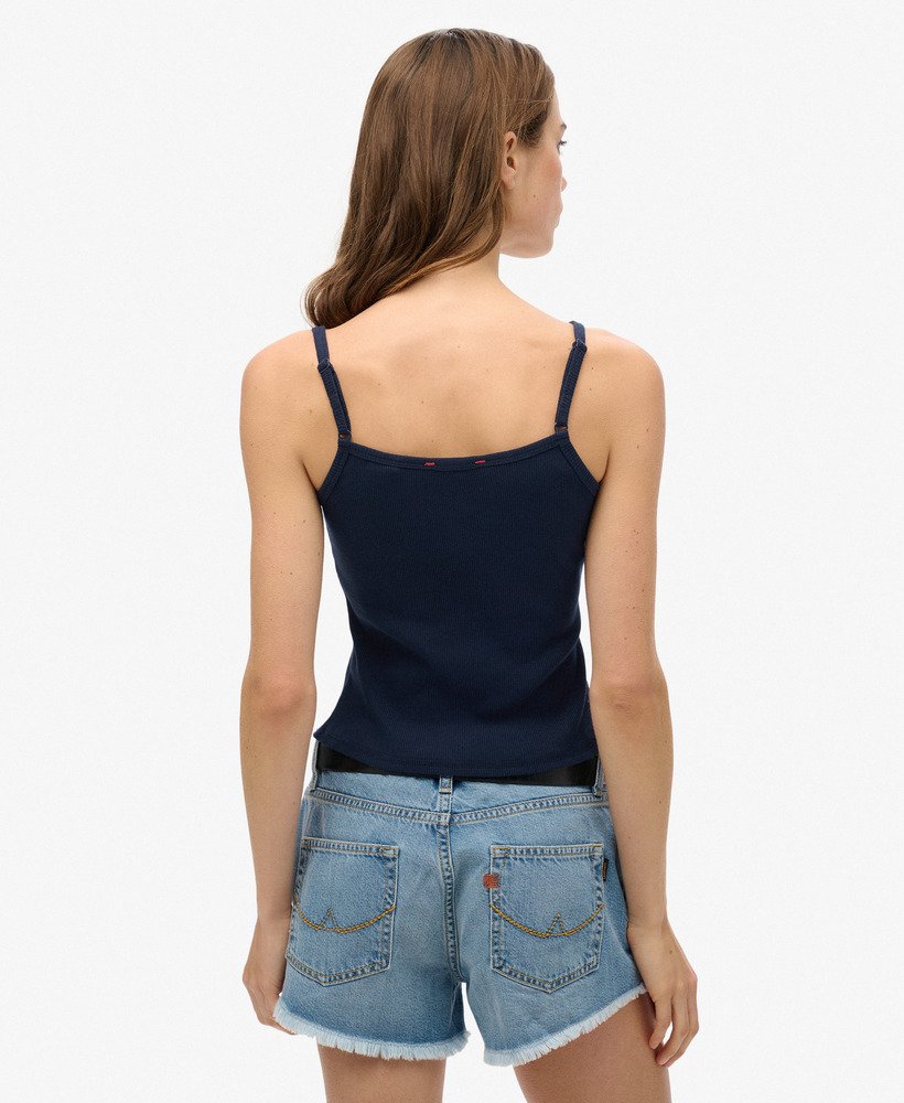 top regata athletic essentials com estampa e botões na cor azul marinho intenso.