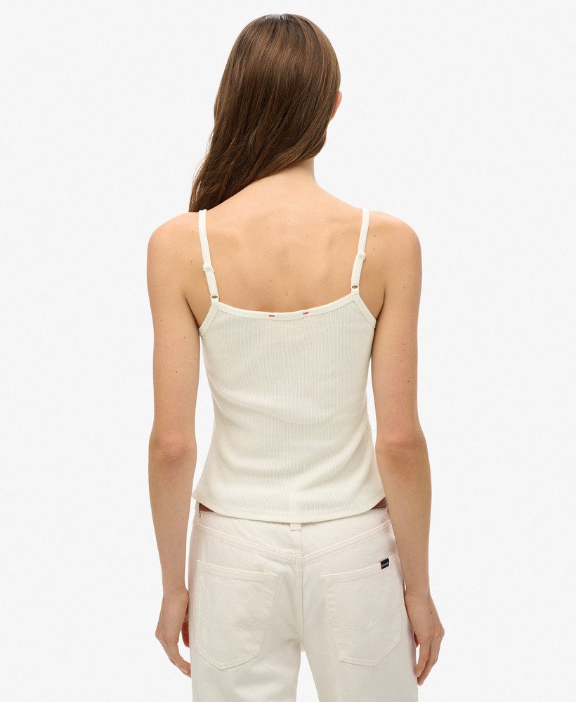 top regata esportivo essencial com estampa e botões na cor off white.