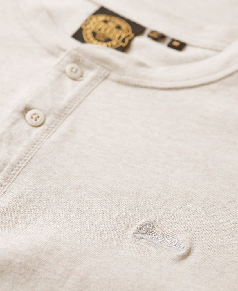 blusa vintage com bordado de logo e meio abotoamento na cor creme mesclado.